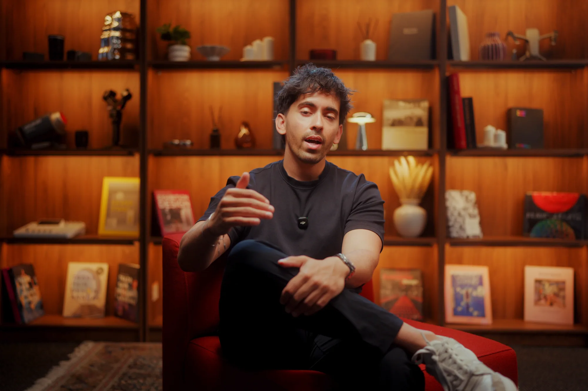 The Founder Talk studio: a red armchair in front of lit timber shelves